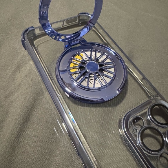 Clear Phone Case with Blue Accents For a 15 Pro Max. Spinning wheel in Center. - Picture 5 of 14